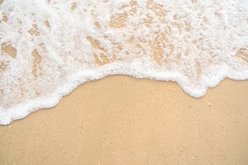 Fototapeta na wymiar softly wave on the sand beach sunset