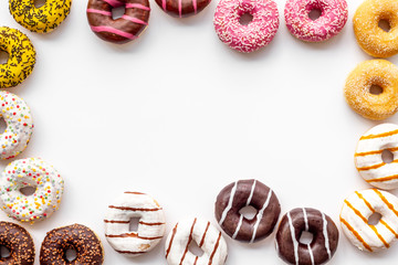 Modern design with bright donuts frame on white background top view mock up