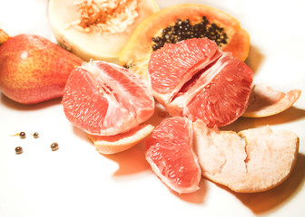 Fruits on white background. Papaya, melon, pear and grapefruit. Art style.