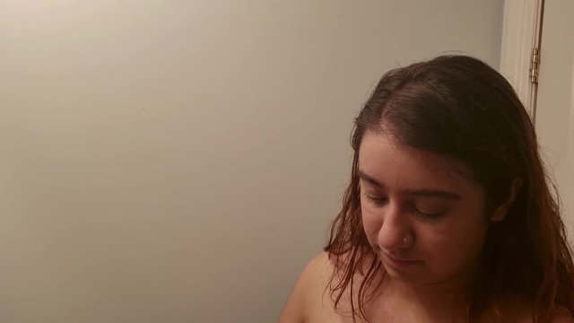 Girl applying concealer on her face slomo