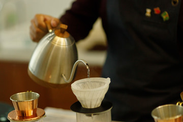 Young man barista pouring coffee.