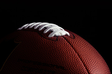 American football on dark background.