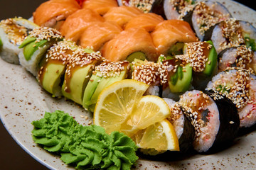 Sushi set with wasabi and lemon on a plate.