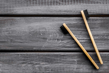 bamboo dental cleaning brush for zero waste lifestyle concept on wooden background top view mock up