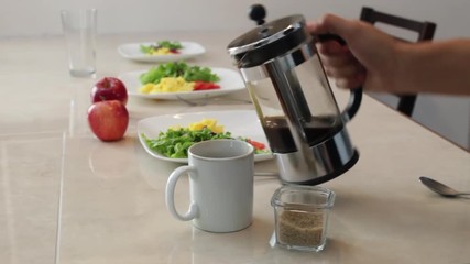 Man pours Black coffee from french press into white mug, adds brown sugar and stirs - Powered by Adobe