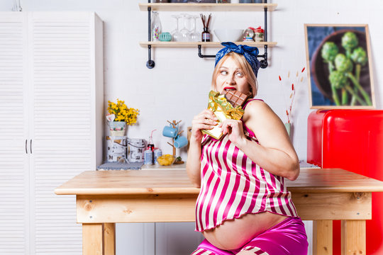 during pregnancy, a woman really wants chocolate, the model eats a large bar of chocolate
