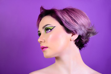Sexy girl with short hair. Portrait of a woman with bright colored hair, all shades of purple. Beautiful lips and makeup. Professional coloring. professional makeup.