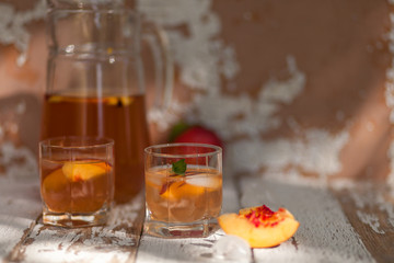Ice tea and nectarine. Jag, two glasses.  A refreshing summer drink