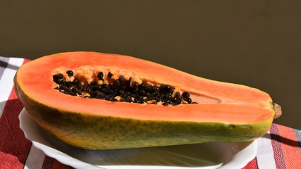 Half a papaya on a tray ready to eat