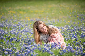 Young Millennial Mother With Daughter During Spring in a Field of Blue Bonnets