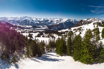 Beautiful winter landscape. People skiing in Mythenregion ski resort, Ibergeregg, Switzerland, Europe