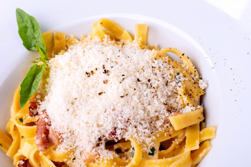 Classic Carbonara pasta, spaghetti with pancetta, bacon, egg, parmesan cheese and green arugula. Macro
