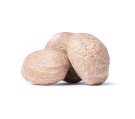 Three nutmeg closeup on a white background