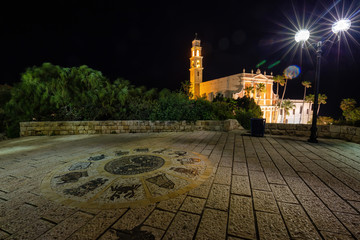 Beautiful view of Wishing Bridge in Abrasha Park with St. Peter's Church in the background during night time. Taken in Old Jaffa, Tel Aviv-Yafo, Israel.