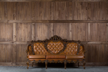 Vintage sofa near wooden wall