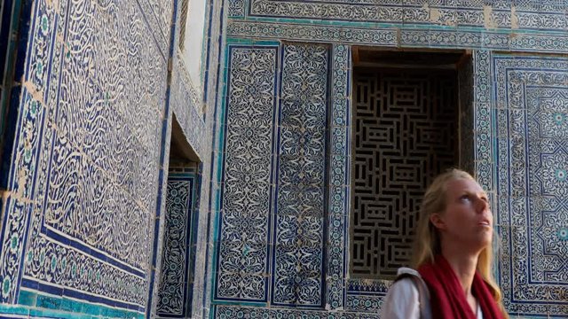 Woman admiring muslim masque decorations for religion and worship