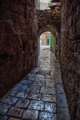 Fototapeta na wymiar Dark and Narrow streets in the Old City of Akko. Taken in Acre, North District, Israel.