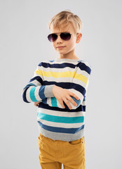 summer, eyewear and fashion concept - portrait of nice little boy in sunglasses and striped pullover over grey background