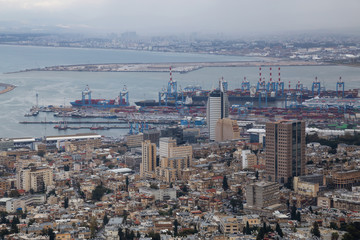Beautiful view of a city on the coast of Mediterranean Sea during a cloudy day. Taken in Haifa, Israel.