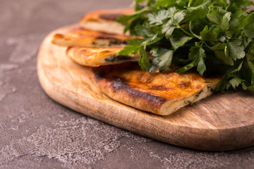 Khachapuri Megrelian with spinach and parsley. Pita bread with cheese