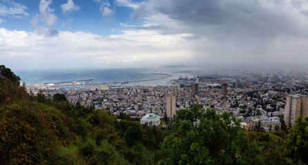 Fototapeta na wymiar Beautiful panoramic view of a city on the coast of Mediterranean Sea during a cloudy day. Taken in Haifa, Israel.