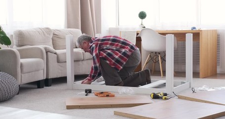 Carpenter assembling table at home