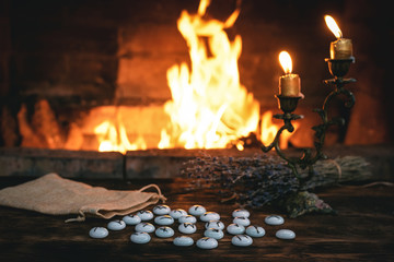 Stone runes on a magic table on a burning fire background. Futune reading concept.