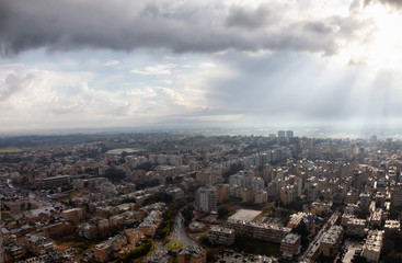 Obraz premium Aerial view of a residential neighborhood in a city during a cloudy sunrise. Taken in Netanya, Center District, Israel.