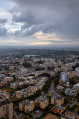 Aerial view of a residential neighborhood in a city during a cloudy sunrise. Taken in Netanya, Center District, Israel.