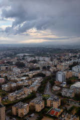 Fototapeta na wymiar Aerial view of a residential neighborhood in a city during a cloudy sunrise. Taken in Netanya, Center District, Israel.