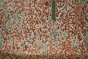 Rusty metal surface of a dark shade close up.