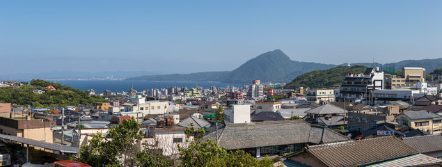Fototapeta na wymiar Panoramic view on Skyline of Beppu City and Bay. Town Oita in the Background. Beppu, Oita, Japan, Asia.