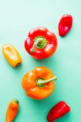 Colored pepper on ray aqua hard top view, natural light,small and big pepper.