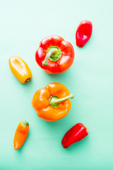Colored pepper on ray aqua hard top view, natural light,small and big pepper.