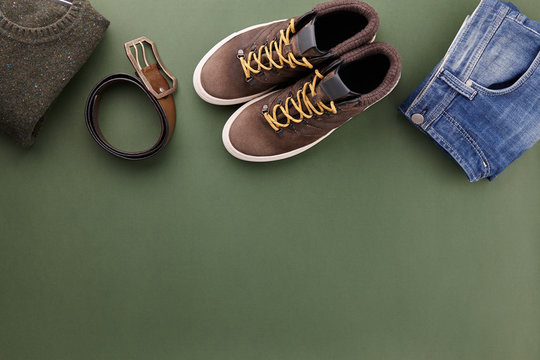 Mens Casual Clothing Outfits And Accessories Flat Lay On Olive Green Background, Top View