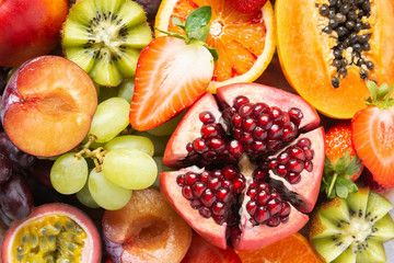 Delicious healthy fruit background mango papaya strawberries oranges passion fruits berries, top view, selective focus