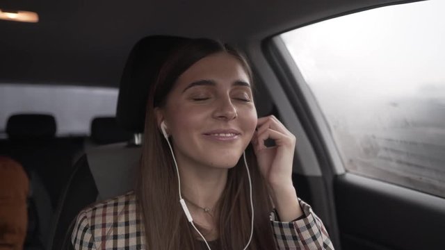 Girl listening to music inside her car
