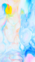 Multicolored background from paints on liquid. Fluid art with different colors. Screen saver. Bright pattern on liquid. Colored paint stains in pop art style