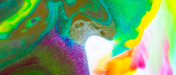 Multicolored background from paints on liquid. Fluid art with different colors. Screen saver. Bright pattern on liquid. Colored paint stains in pop art style