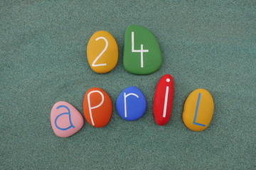 24 April, calendar date with colored stones over green sand