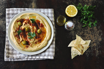 Fresh homemade hummus with olive oil and spices. Middle Eastern cuisine.