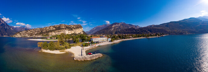 Fototapeta premium Torbole,Lago di Garda ,Italy - 19 October 2018:A rial Panorama of Torbole and Garda lake in the in the autumn, a small town on Lake Garda, Italy. Europa