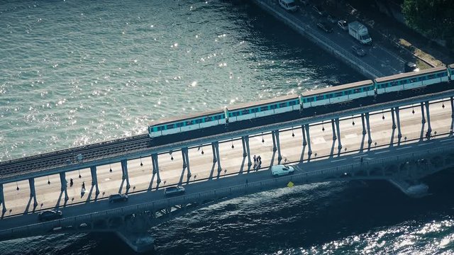 Aerial view of traffic of metrao train and car vehicles crossing Seine river on Bir Hakeim bridge in Paris, France