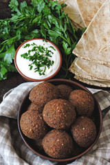 Falafel with pita bread, sauce and herbs. Middle Eastern cuisine.