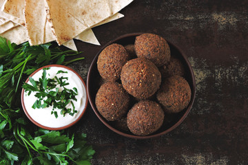 Falafel with pita bread, sauce and herbs. Middle Eastern cuisine.