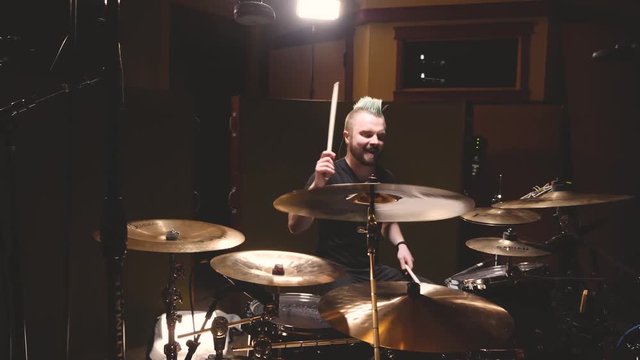 Drummer performing in a studio setting.