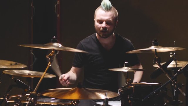 Drummer performing in a studio setting.