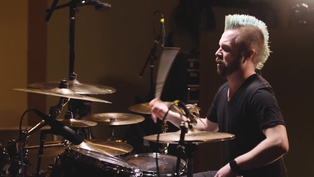Drummer performing in a studio setting.