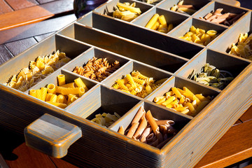 Italian pasta collection in wooden box.
