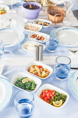 Varioius meze starters in an outdoor greek restaurant. Healthy vegetarian snacks. Local mediterranean cuisine